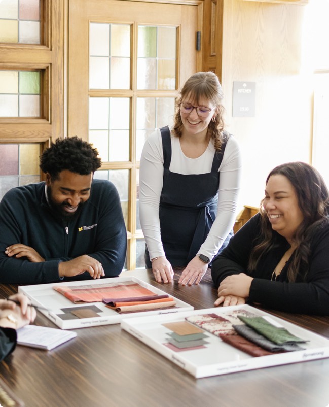 The DEI team working on fabric choices for a lounge renovation